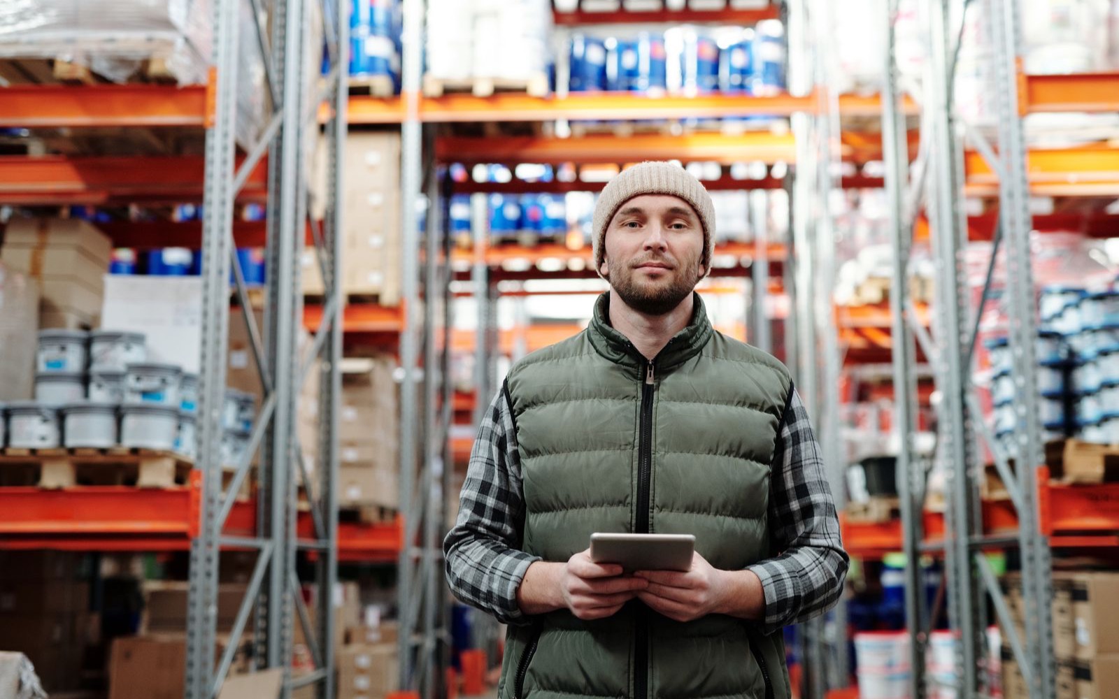 Trades owner reviewing a tablet on a warehouse floor